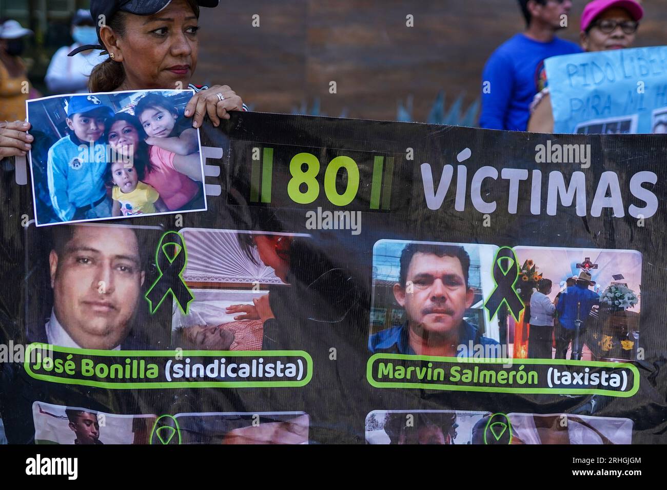 San Salvador, El Salvador. 16th Aug, 2023. A woman holds a banner showing pictures of inmates who's deaths haven't been clarified during a protest of the Movement of Victims of the State of Emergency (MOVIR) to demand the release of their jailed relatives, alleged to be wrongfully detained. More than 70 thousand alleged gang members have been detained during El Salvador's state of emergency ordered by President Nayib Bukele that has been extended 17 months. Credit: SOPA Images Limited/Alamy Live News Stock Photo