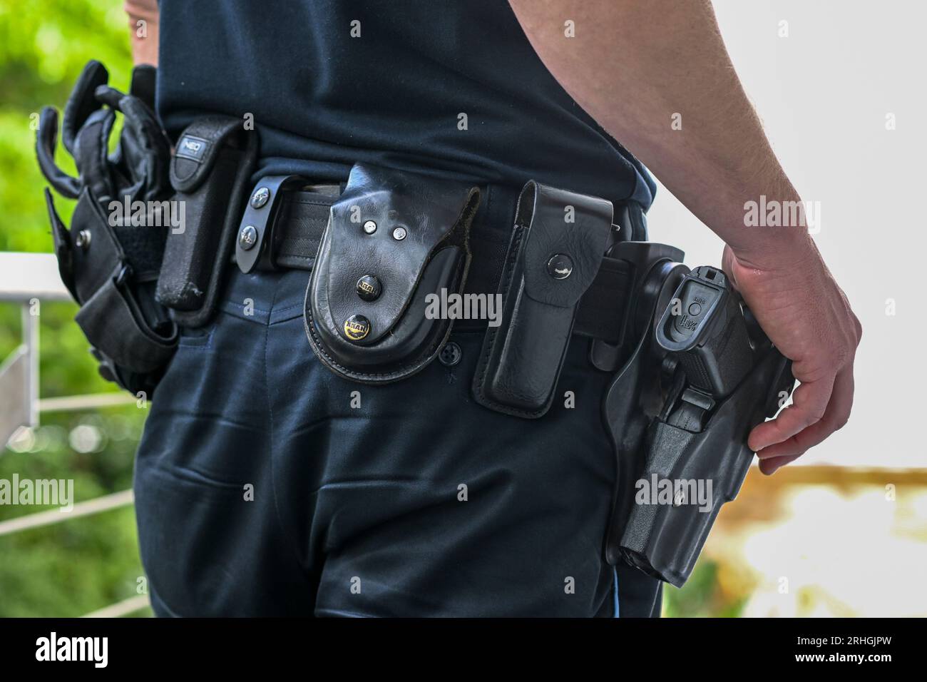 Erfurt, Germany. 16th Aug, 2023. A police officer with his service weapon and handcuffs hanging from his belt. Credit: Jens Kalaene/dpa/Alamy Live News Stock Photo