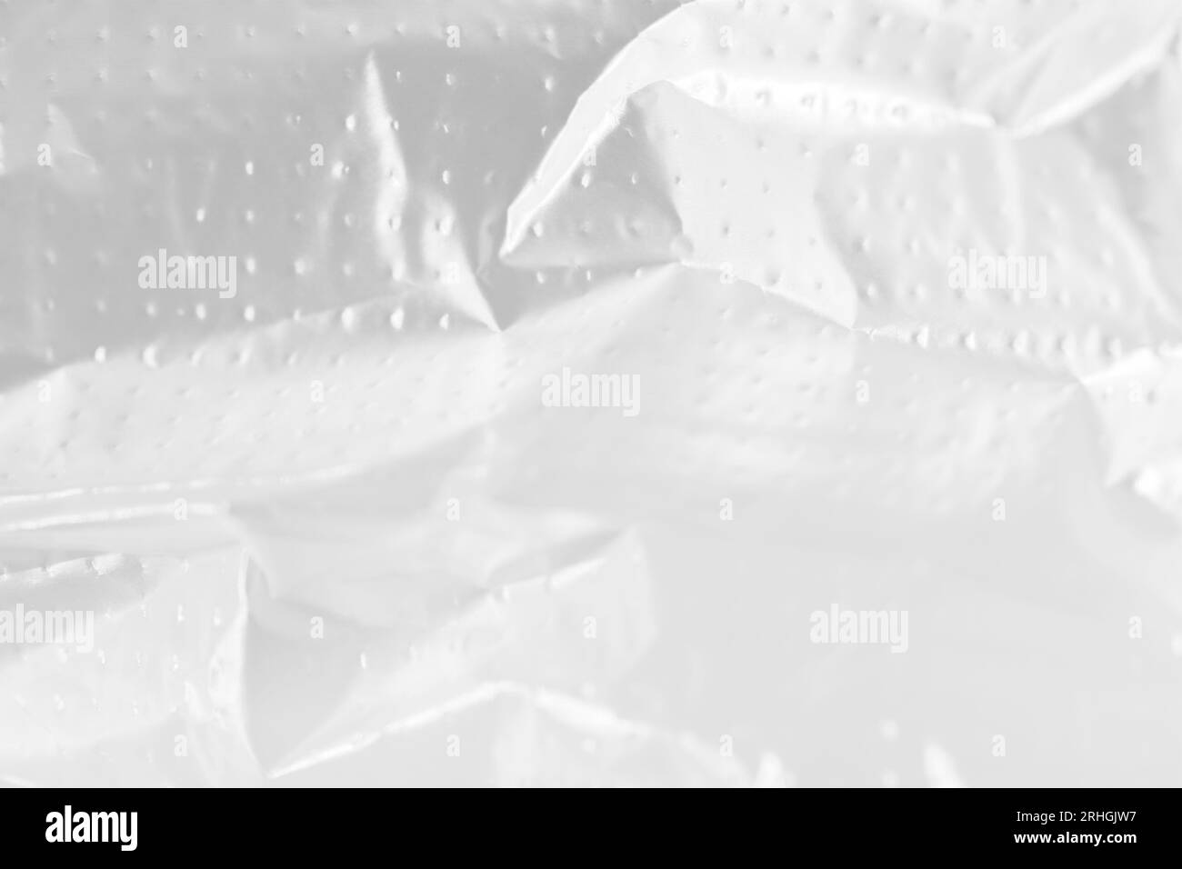 Abstract background of white wrinkled plastic cellophane film texture