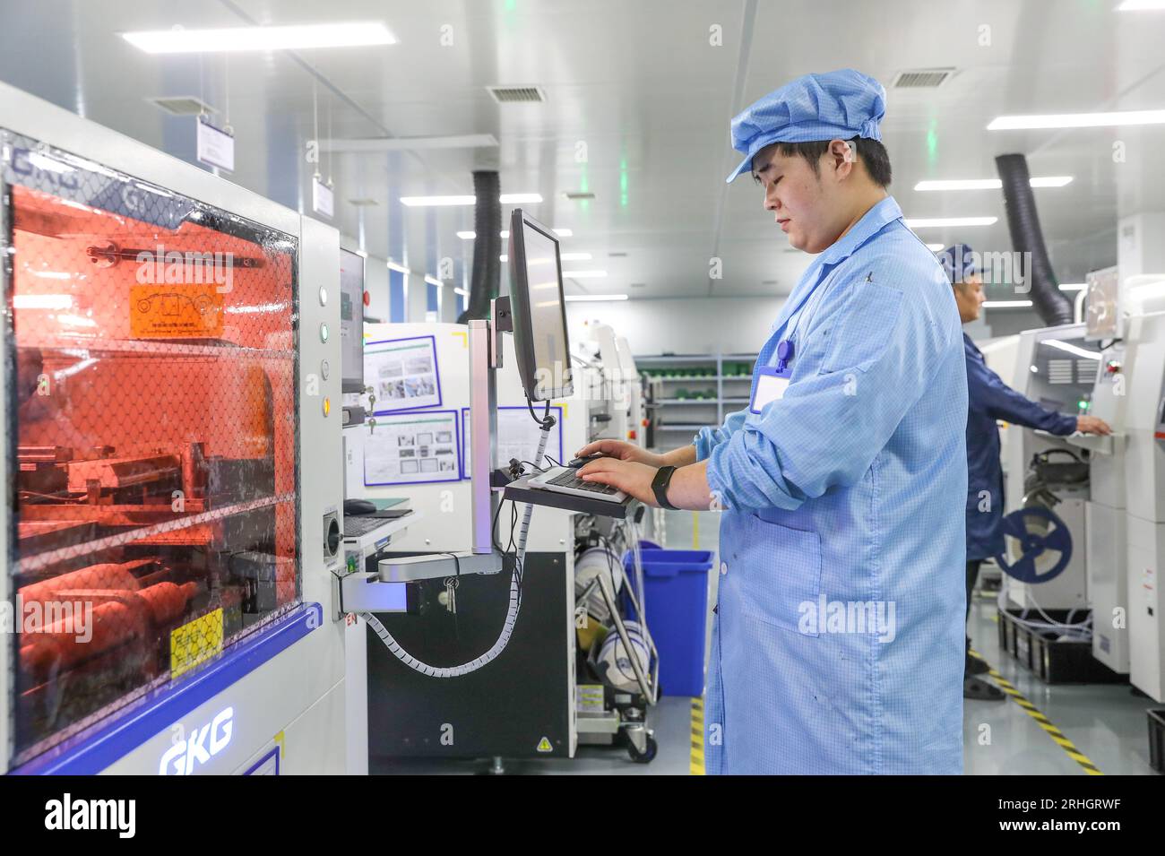 HUZHOU, CHINA - AUGUST 17, 2023 - A staff member produces integrated circuit chips at the production workshop of Zhejiang Jingshi Microelectronics Tec Stock Photo