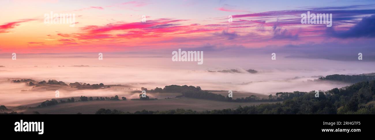 Misty morning sunrise from Bo Peep hill on the south downs east Sussex south east England UK Stock Photo