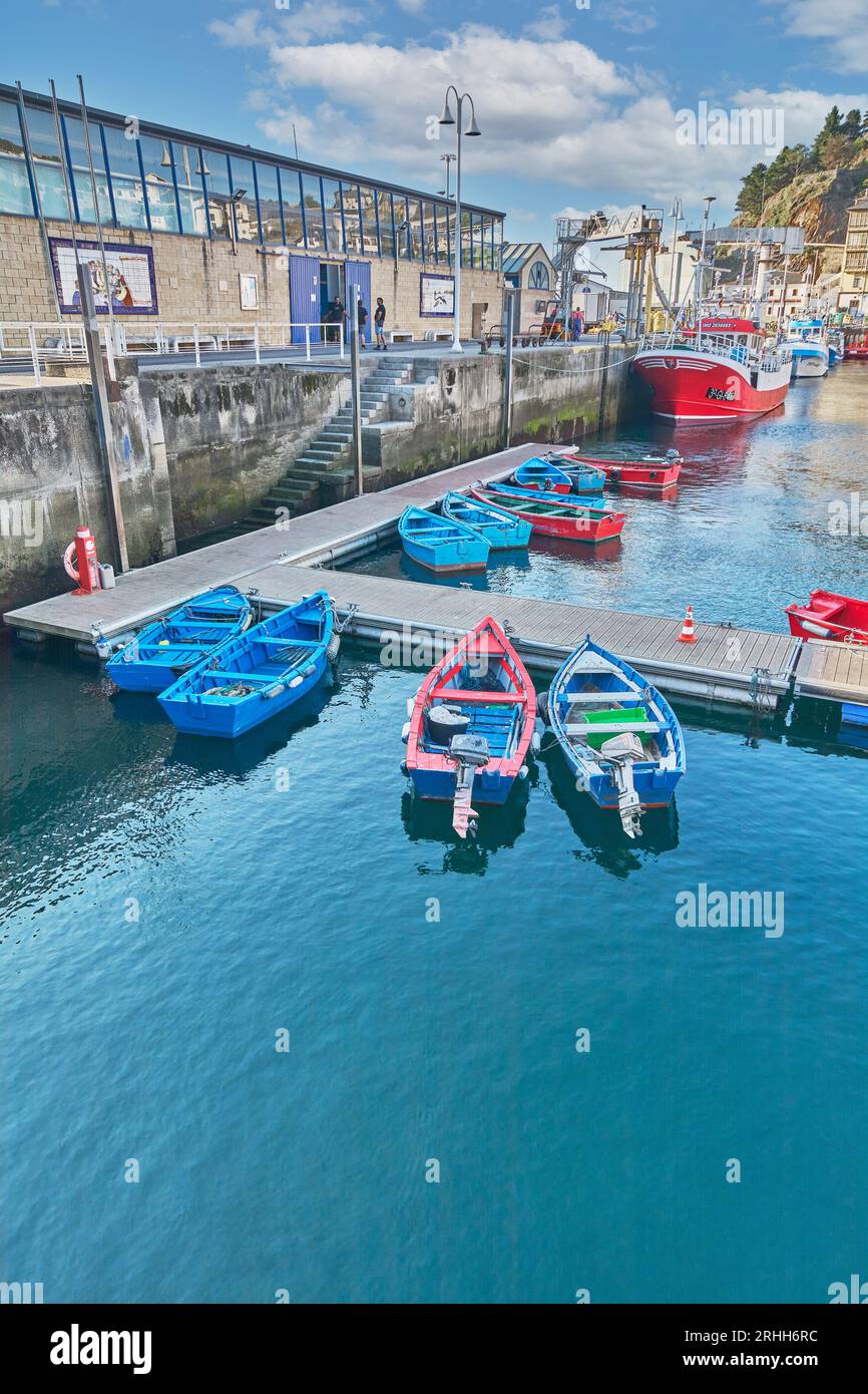 Red and blue fishing boats moored in the seaport of Luarca. Stock Photo