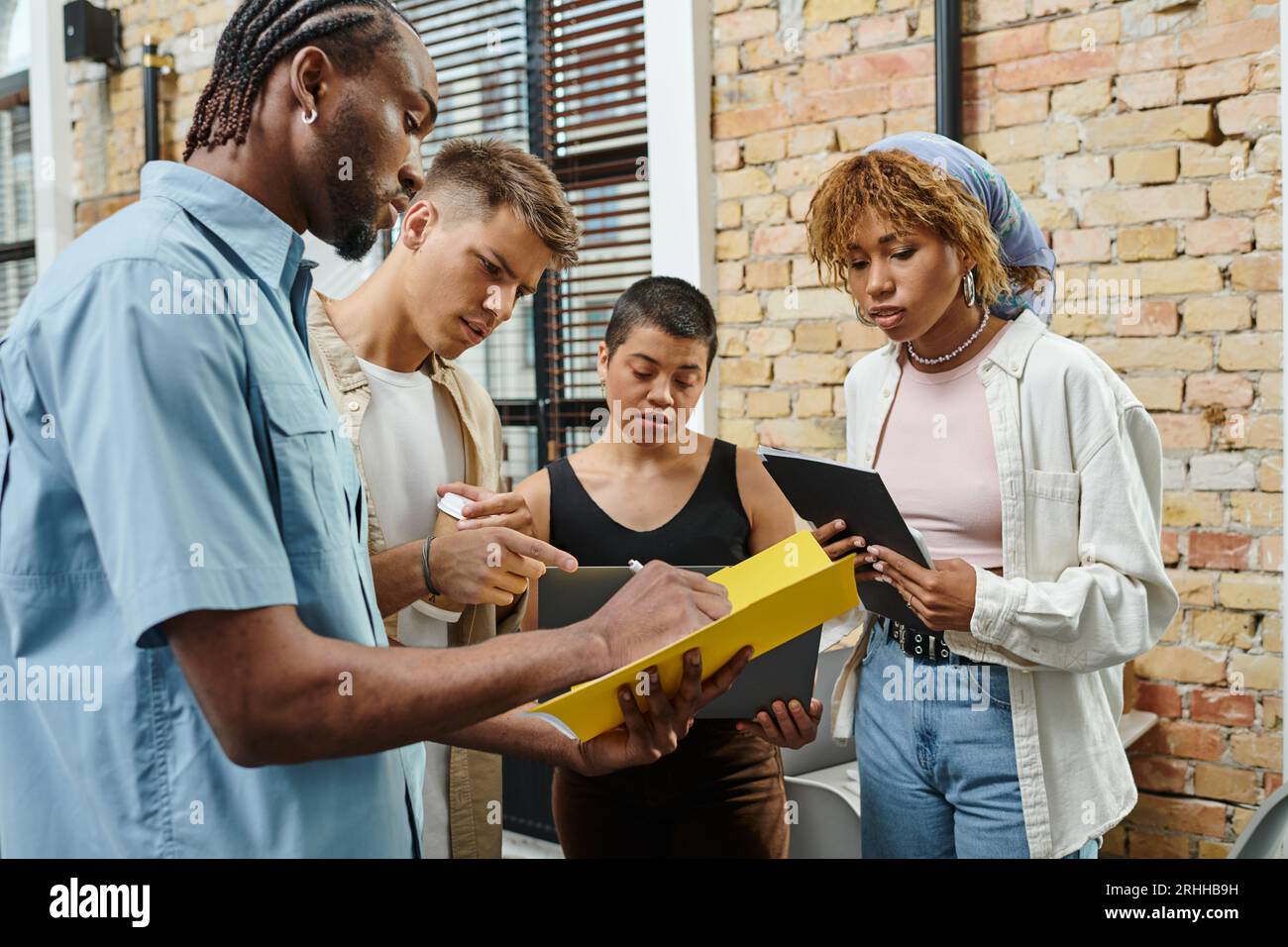 concentrated colleagues discussing project, generation z people in ...