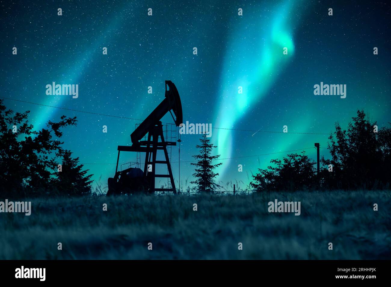 Pump jack silhouette on night sky with Northern light. Oil pump against