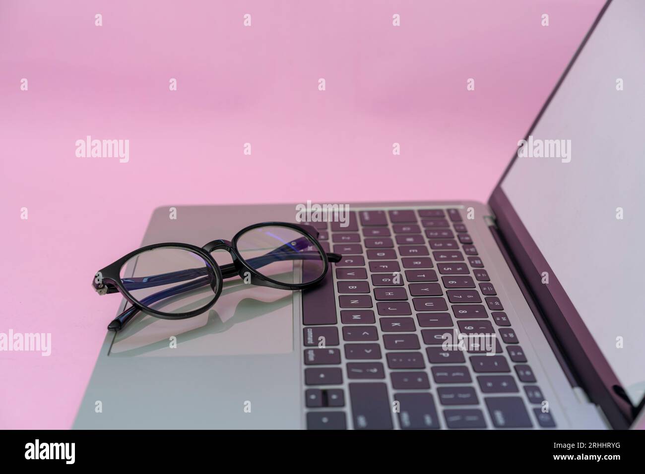 Glasses are placed on a laptop Stock Photo