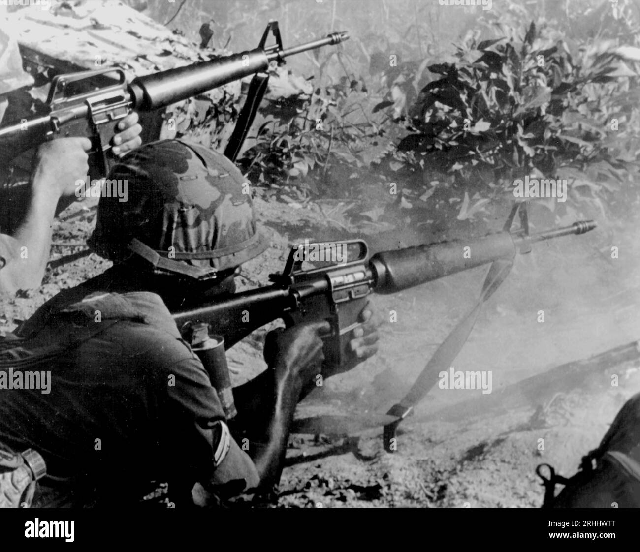 LOC NINH, VIETNAM - October / November 1967 - US Army GIs engage Viet Cong forces near Loc Ninh, close to the Laos border during October and November Stock Photo