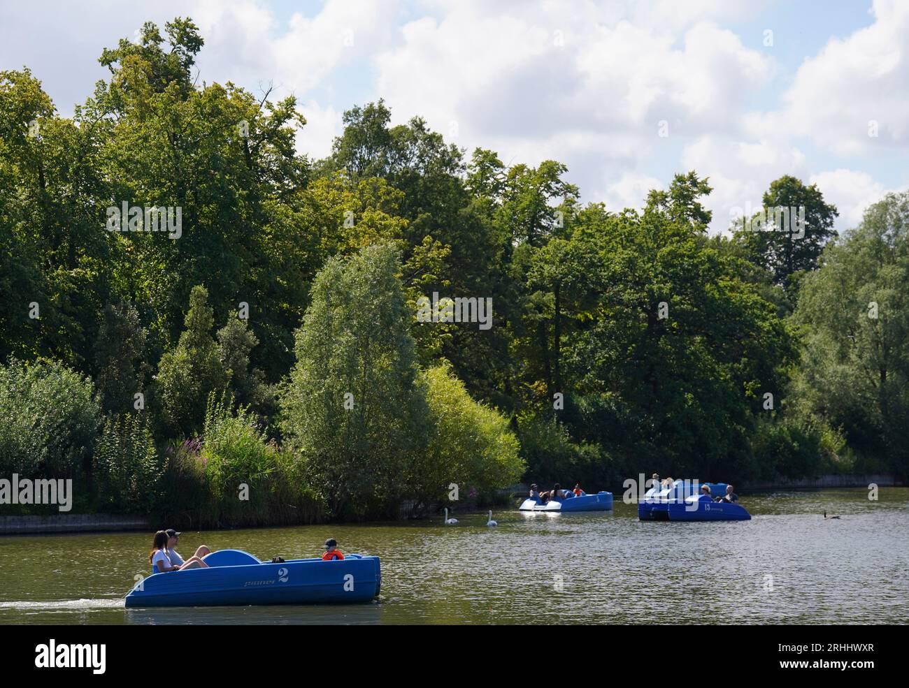 Visitors to Crystal Palace Park, London, travel by pedalo along the