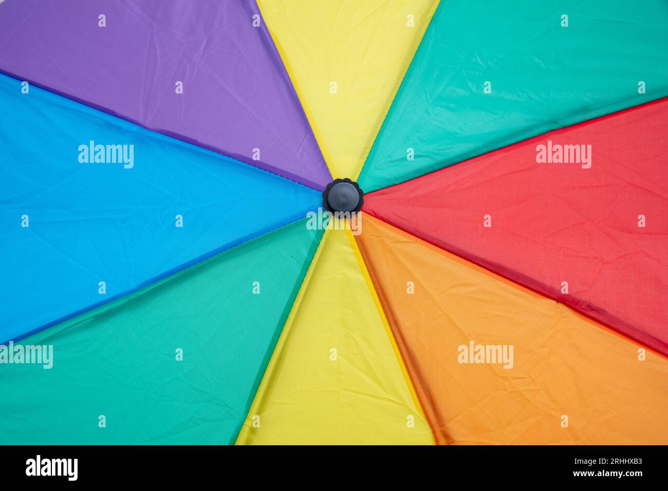 Rainbow colors umbrella closeup, a vibrant display of colors background Stock Photo