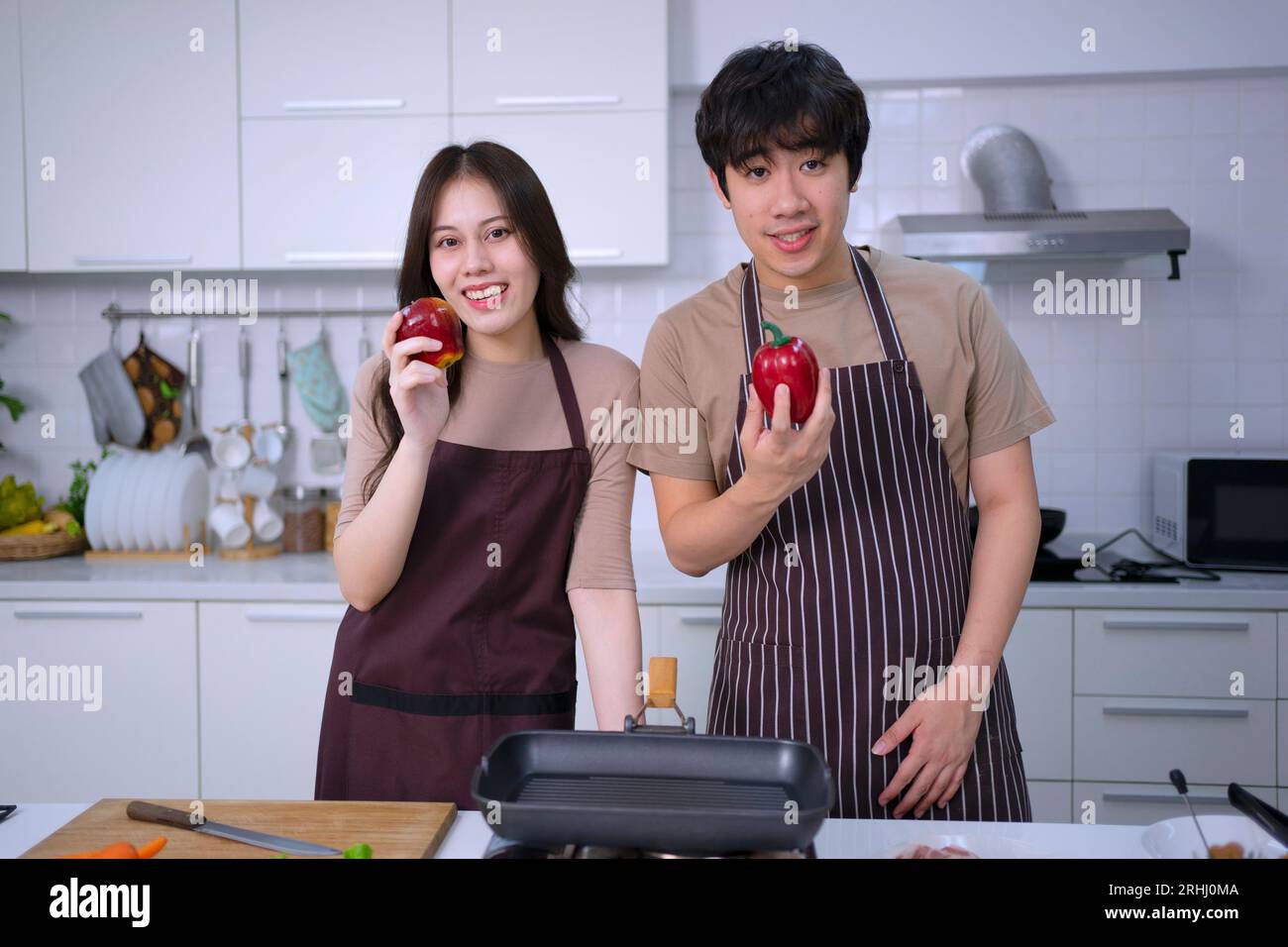 Young couple is livestreaming in kitchen. Lifestyle and leisure activity concept. Stock Photo