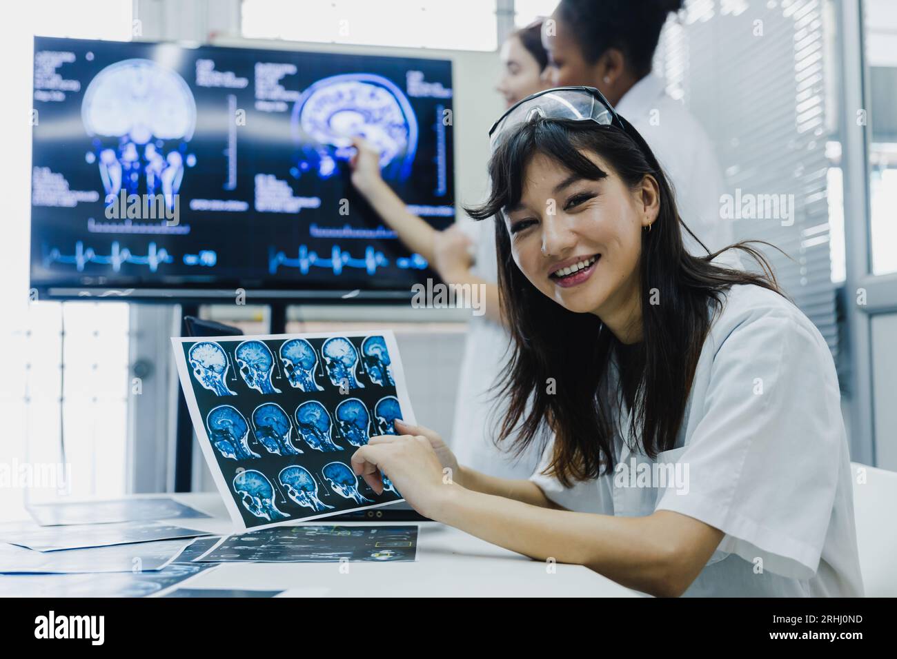 Team of female doctor check on scan results paper and looking at ...