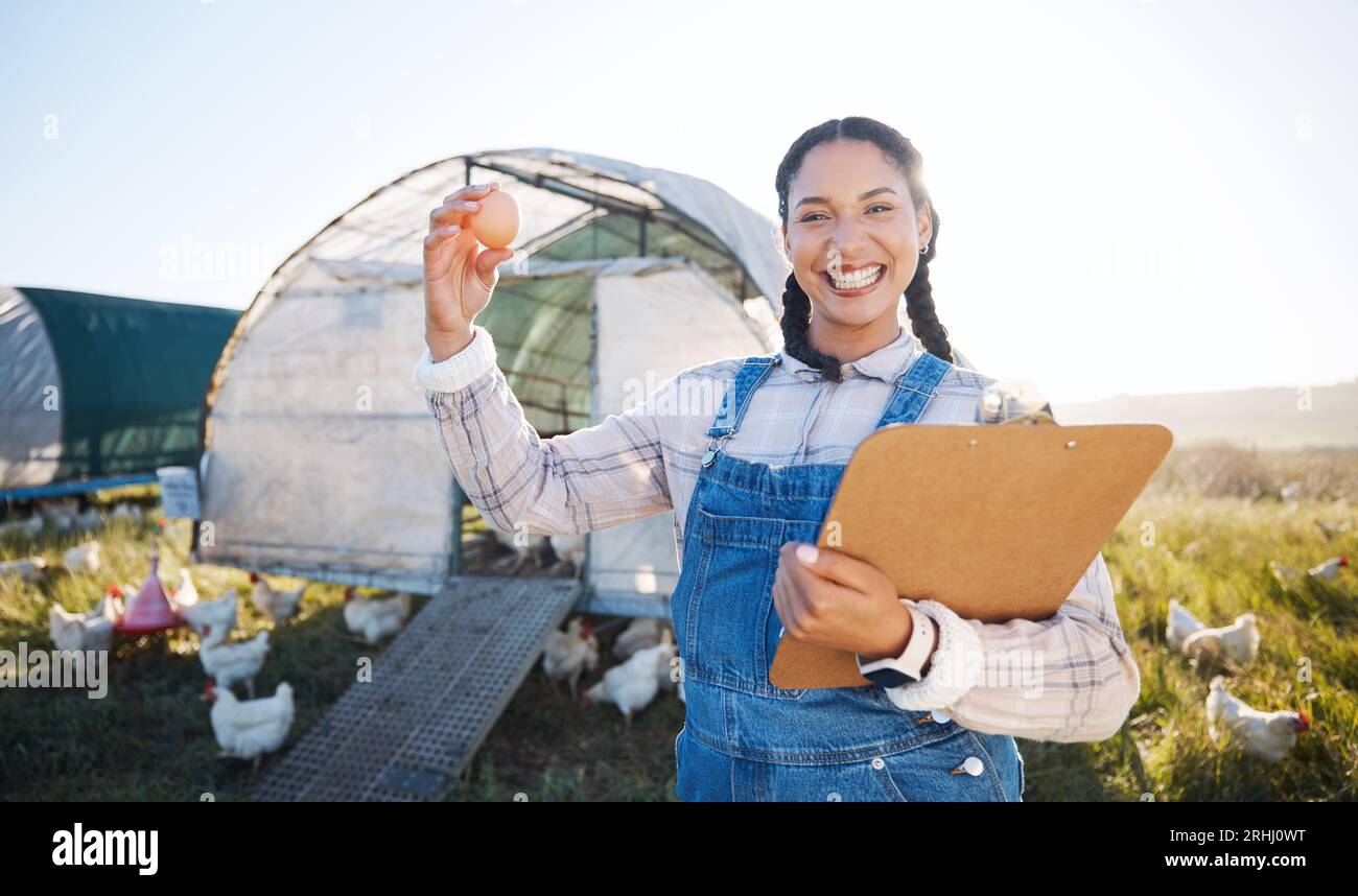 Farm, poultry and a woman with an egg for inspection and a clipboard ...