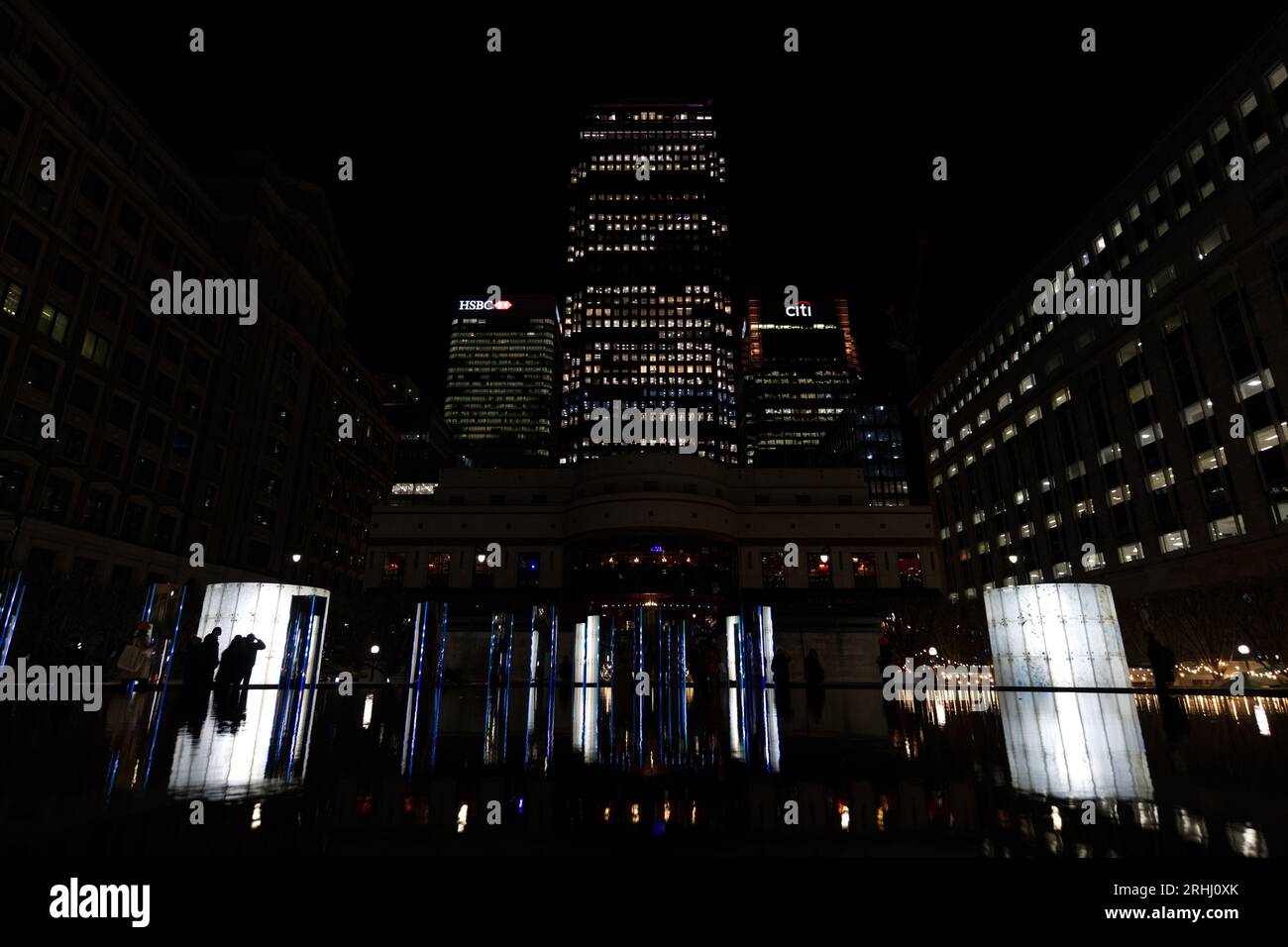 Office blocks at night and reflections in water - Canary Wharf Winter Lights art festival 2023 Stock Photo