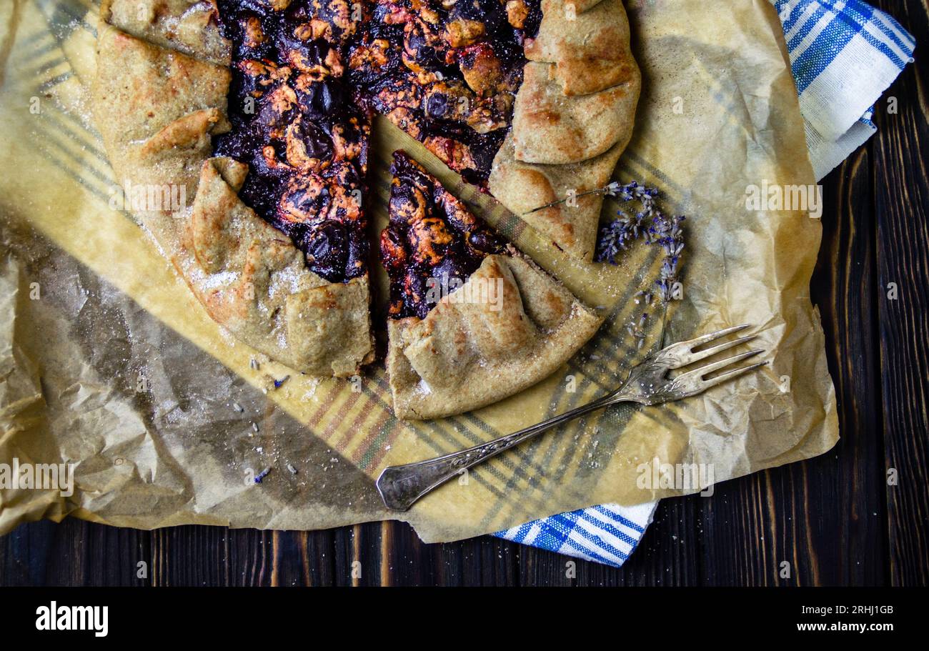 Food photography of dessert course with delicious plums, pie crust in vintage style Stock Photo