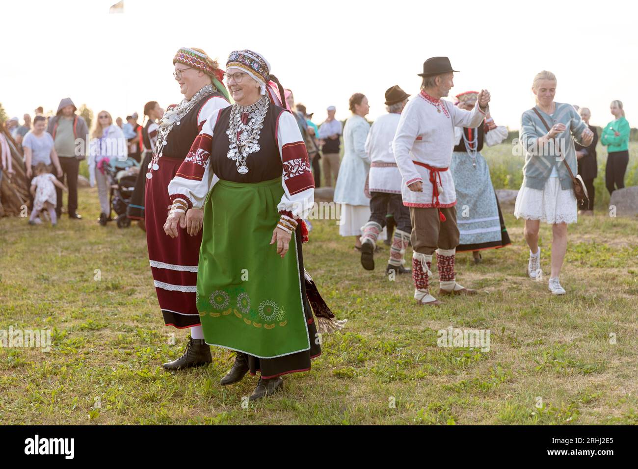 Women in traditional seto estonian costumes dancing, celebrating estonian national holiday 