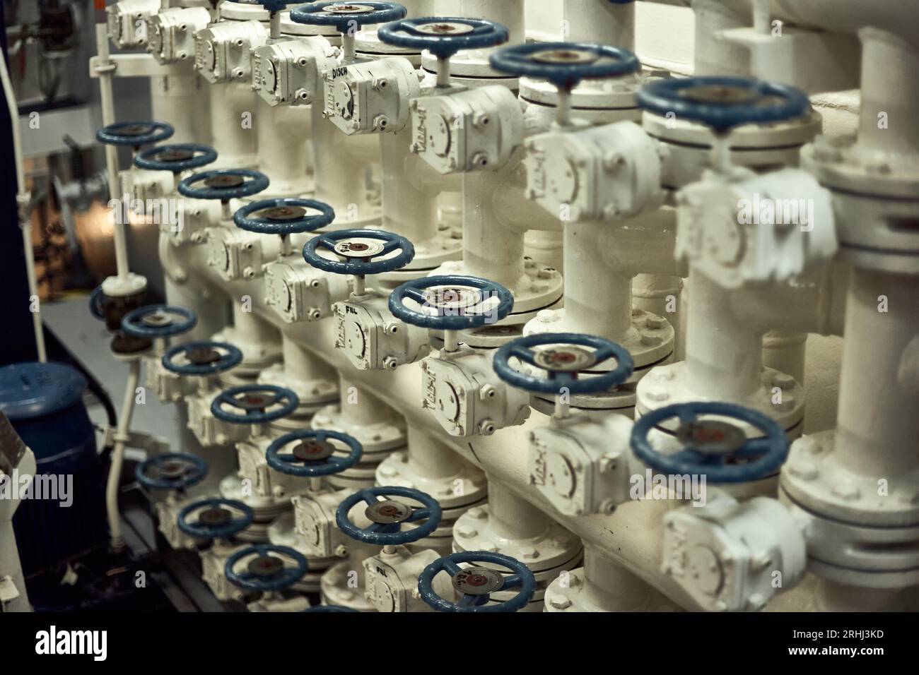 Butterfly  valves manifold in engine room for fresh water cargo operations with blue valve handles. Stock Photo