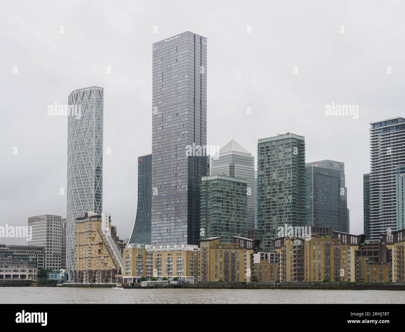 Canary Wharf financial centre from the South Bank of the River Thames in London UK on a grey and gloomy day Stock Photo