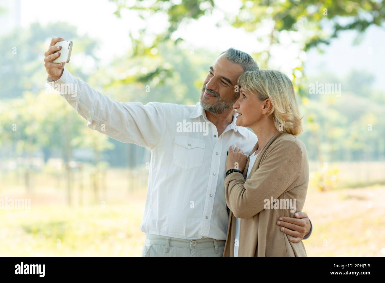 Happy Senior Couple lifestyle couple selfie in park as husband. Stock Photo