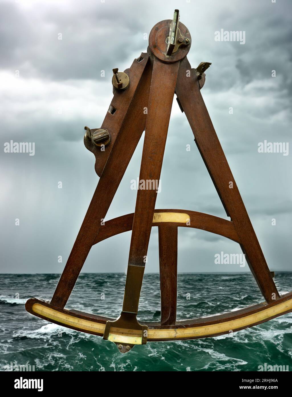 HADLEY'S QUADRANT OCTANT SEXTANT  Britain, 18th Century London'. Mahogany 'T-frame' and radius arm with clamp. Index with a 90-degree arc; diagonal scale for dividing the increments on the index scale. This Quadrant patented in 1734 by John Hadley was adopted by most British navigators.An Octant is a navigational positioning device. Invented by Isaac Newton and perfected by John Hadley and Thomas Godfrey in 1742, it aligned the horizon and the stars more efficiently and was easier, quicker and more accurate to use than previous navigation instruments. Stock Photo