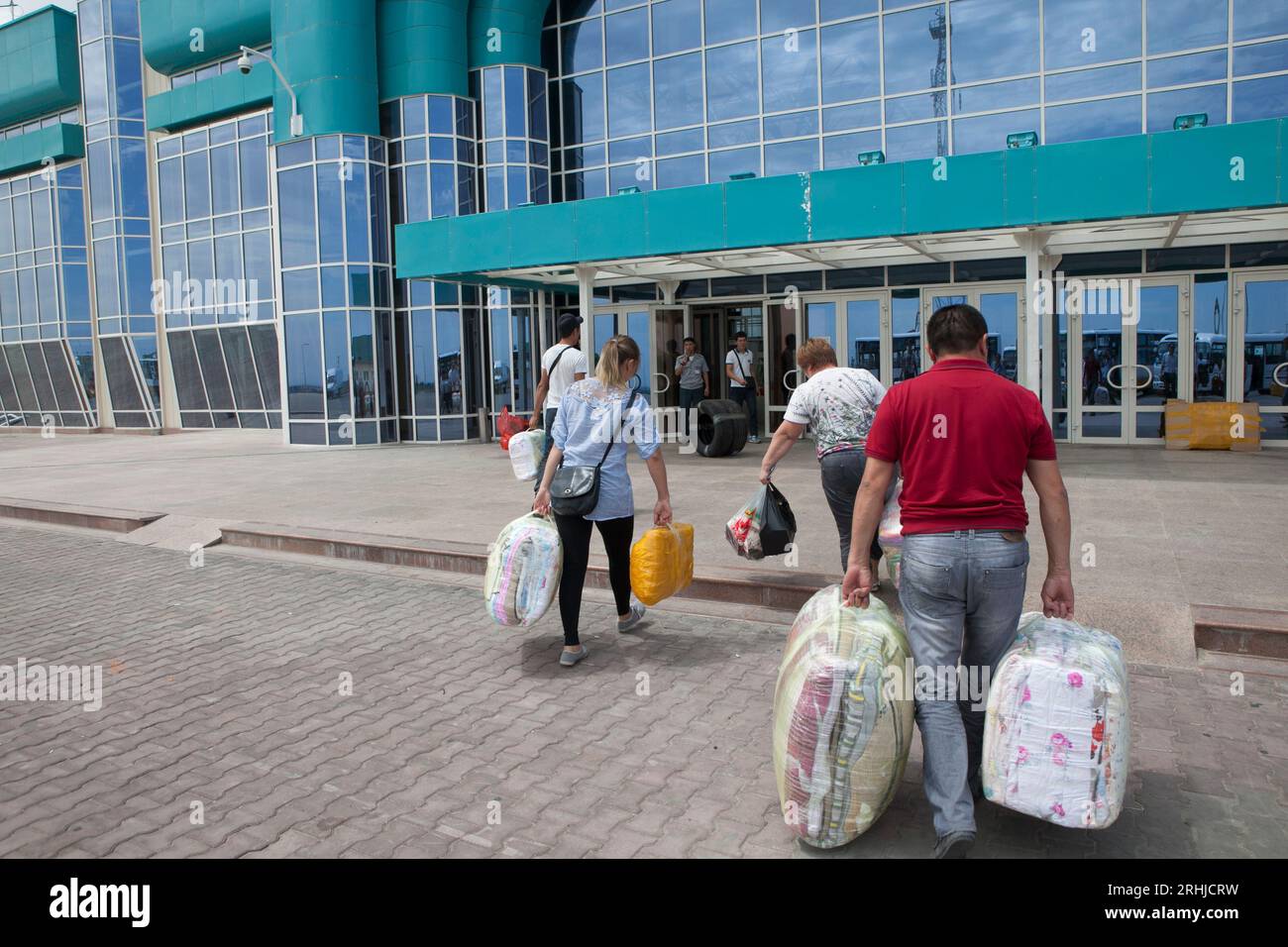 Kazakhs returning to Kazakhstan from the Khorgos Special Economic Zone on the China-Kazakhstan border must enter a large new customs facility. Stock Photo