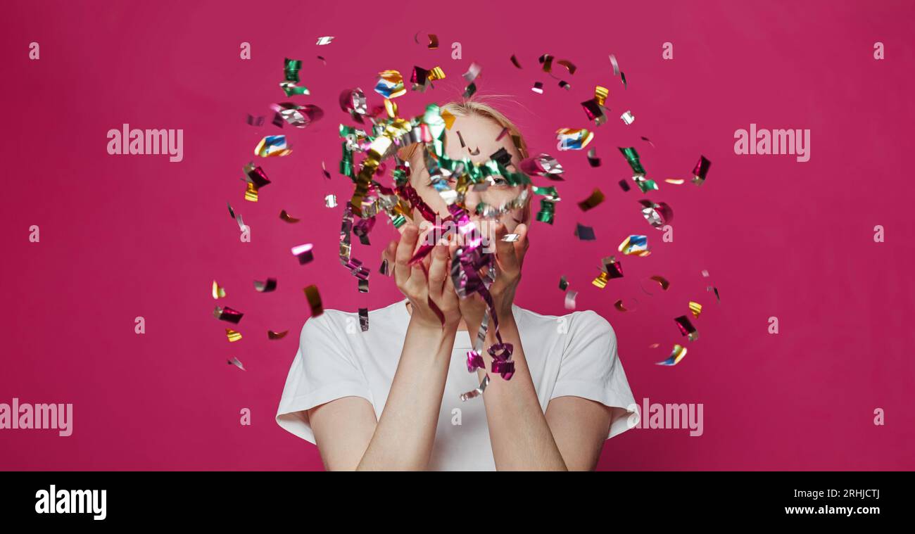 Cheerful woman blowing confetti hi-res stock photography and images - Alamy