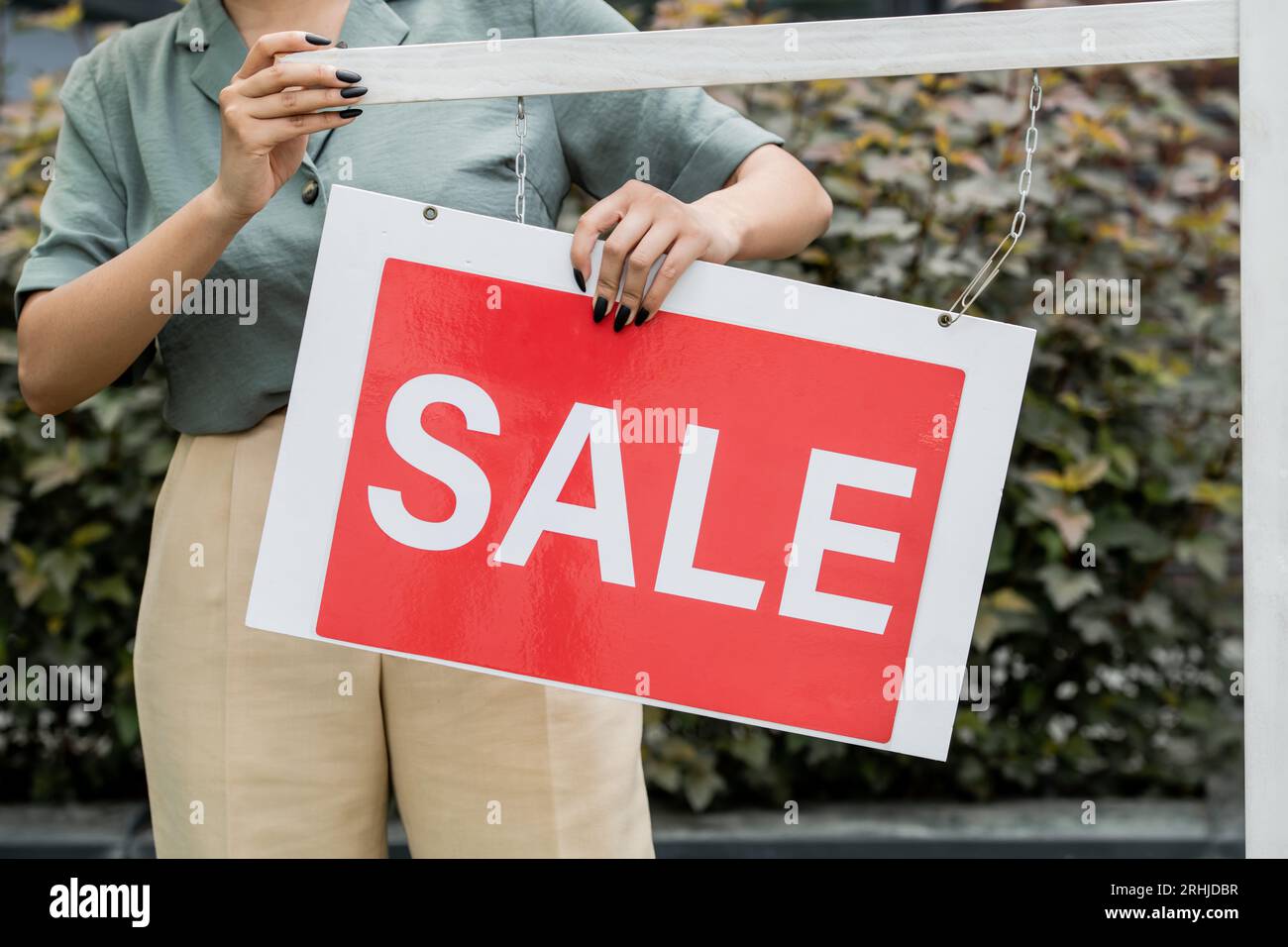 partial view of african american real estate broker holding for sale