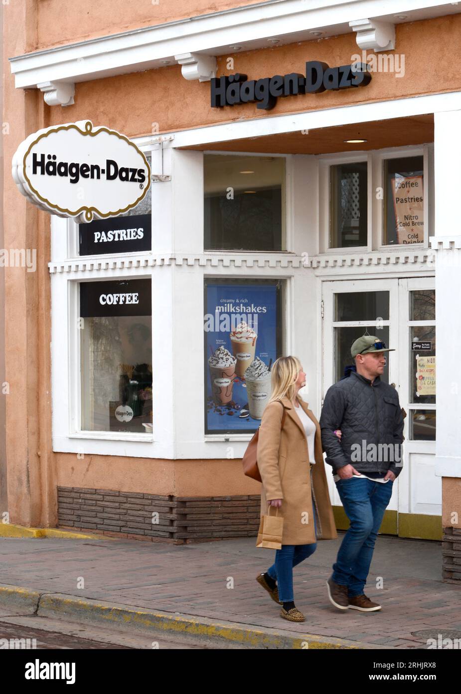 A couple walk past a HaagenDazs ice cream shop in Santa Fe, New Mexico