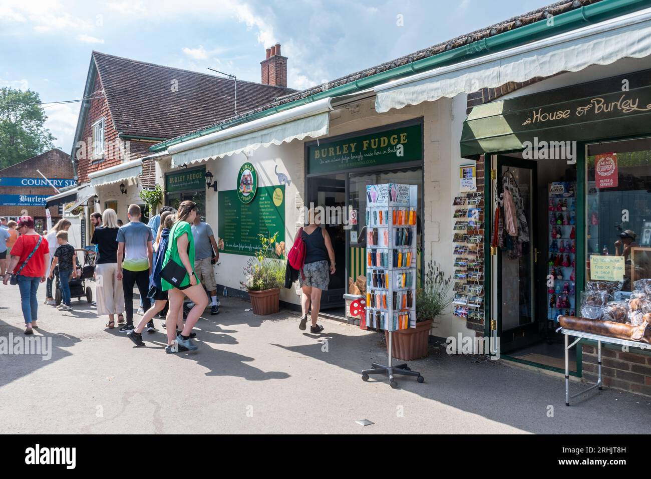 People tourists shopping in Burley village in the New Forest National Park during the summer holidays, Hampshire, England, UK Stock Photo