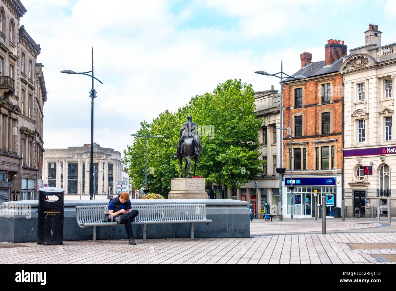 Wolverhampton Bench A person sits on a bench in Queens Square in Wolverhampton City Centre ...