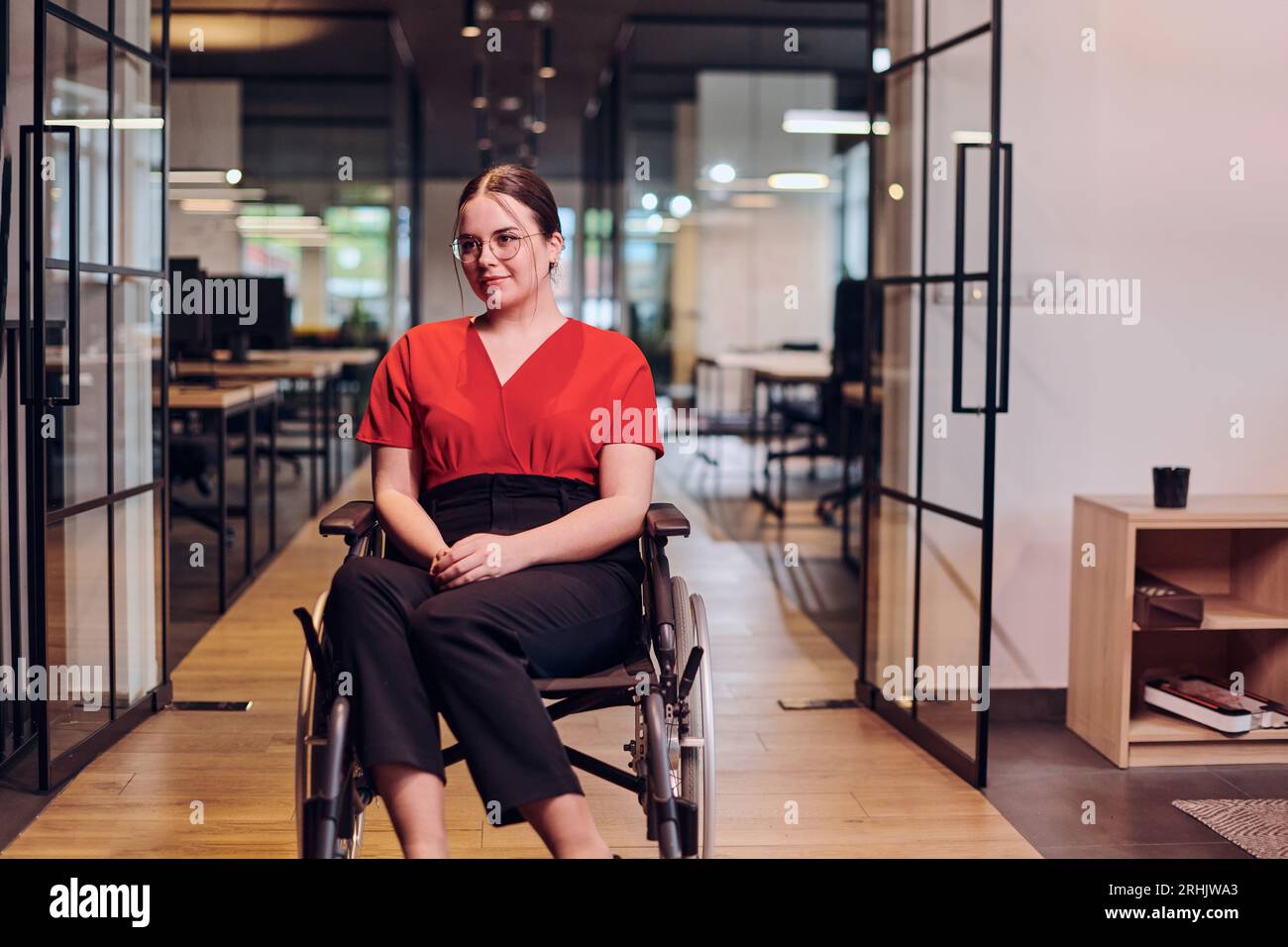 A modern young businesswoman in a wheelchair is surrounded by an ...