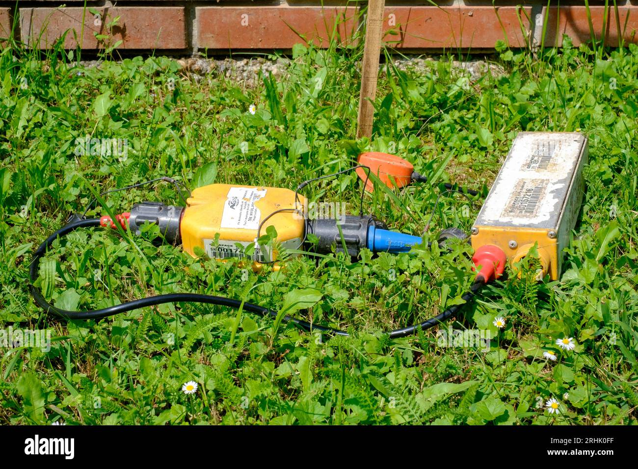 meter with ancillary metering equipment for detecting underground oil reserves laying on ground of rural country lane zala county hungary Stock Photo