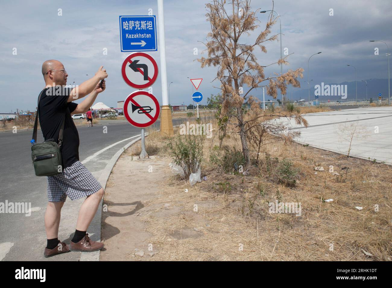 A man takes a photo in the  Khorgos Special Economic Zone on the China-Kazakhstan border. Stock Photo