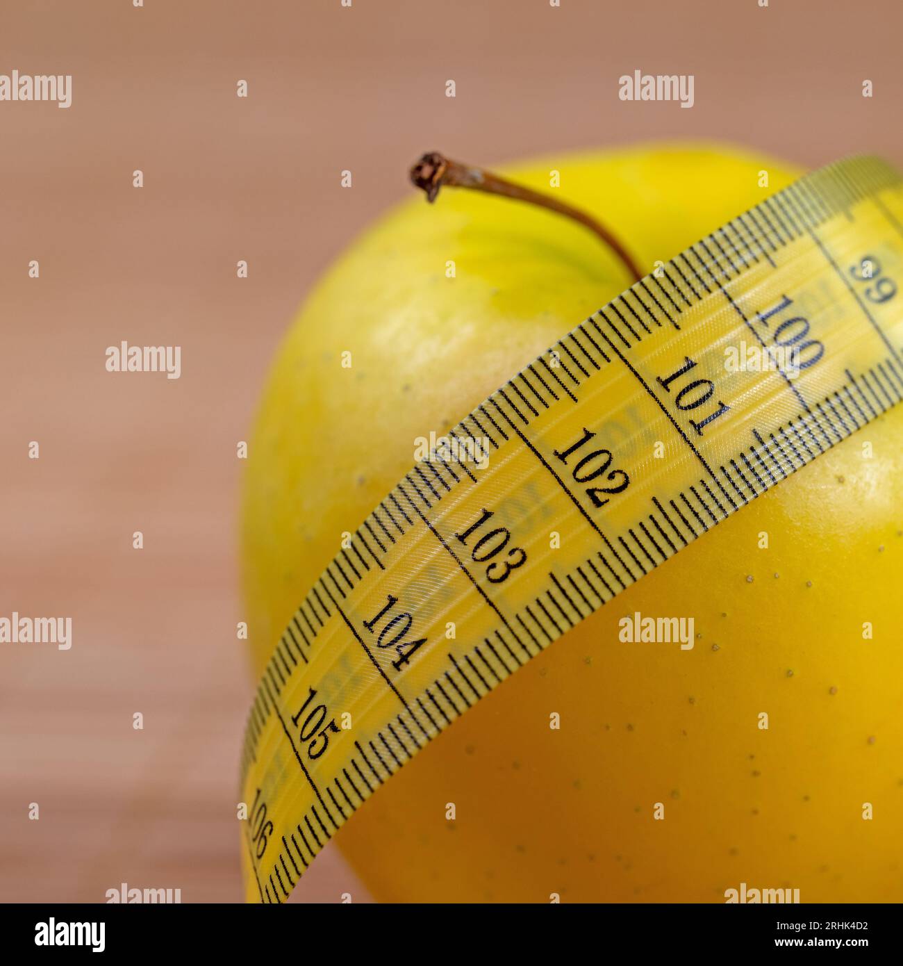 Apple and tape measure symbolic of weight reduction Stock Photo Alamy