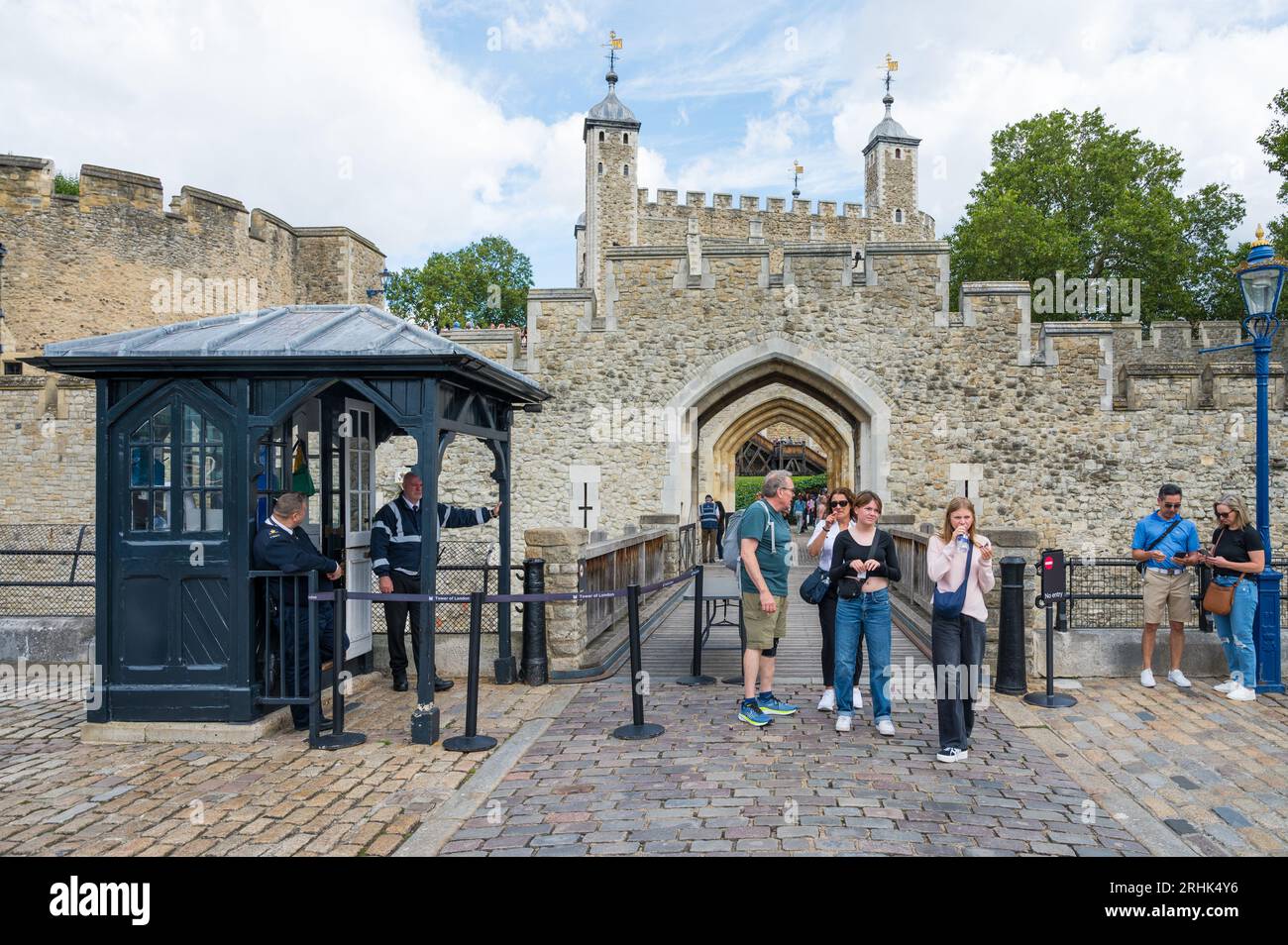 People exit the Tower of London. Security cabin and guard control at exit onto Tower Wharf. London, England, UK Stock Photo
