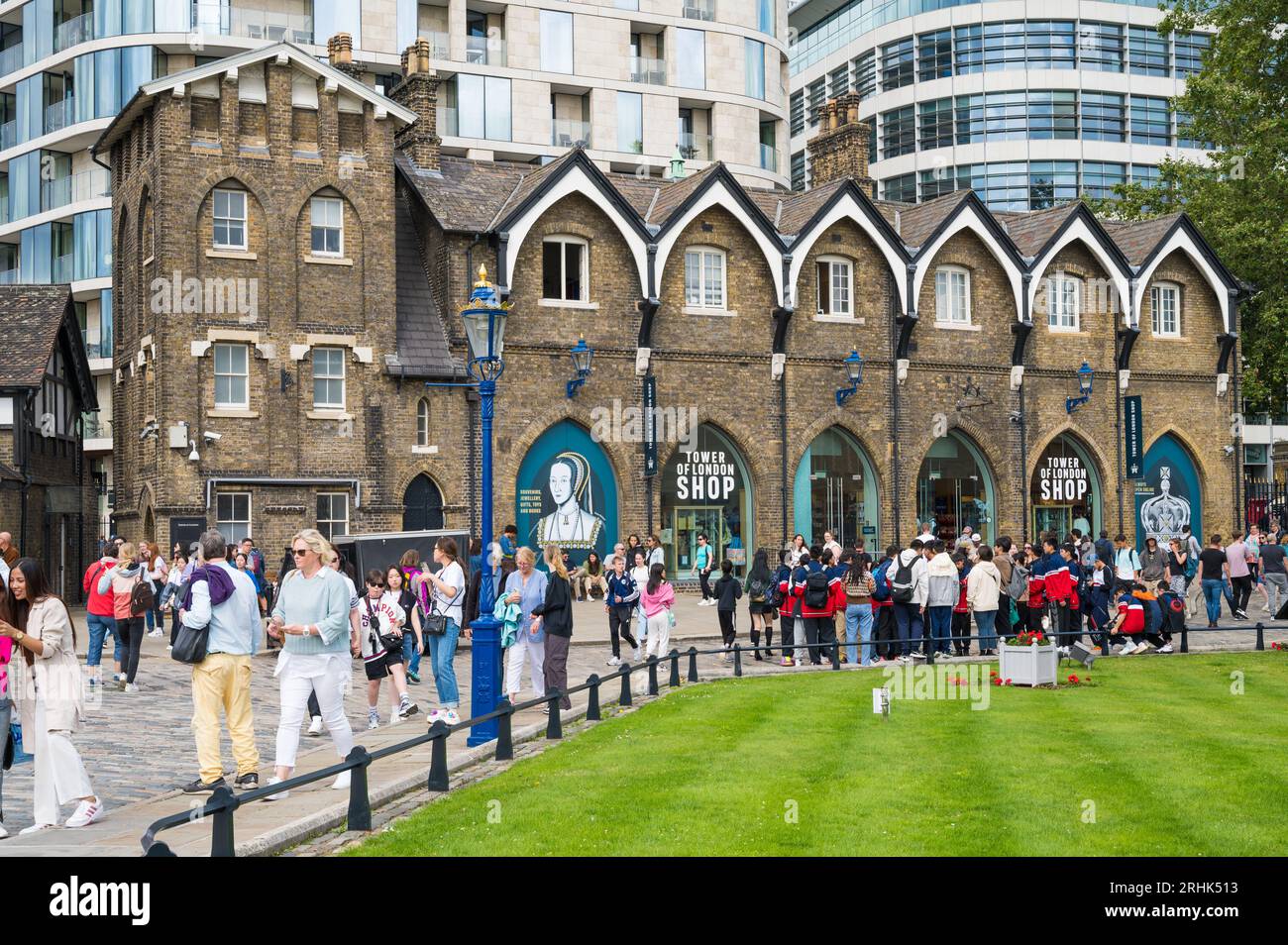 Tourists and sightseers in Tower Place West with Tower of London Shop in background. London, England, UK Stock Photo