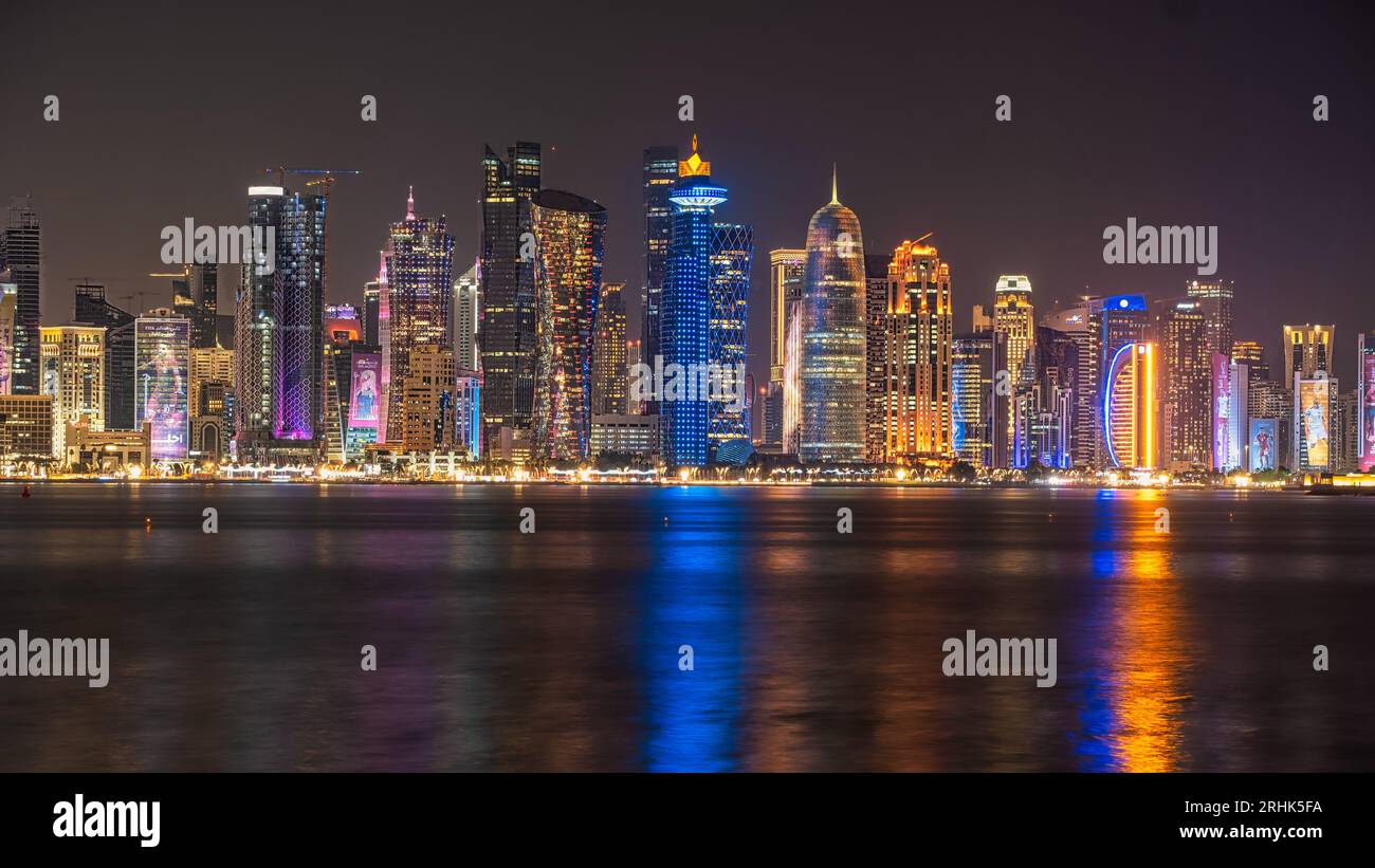 Beneath the enchanting night sky of Qatar's 2022 FIFA World Cup, the Corniche promenade transforms into a mesmerizing scene. Expertly captured through Stock Photo