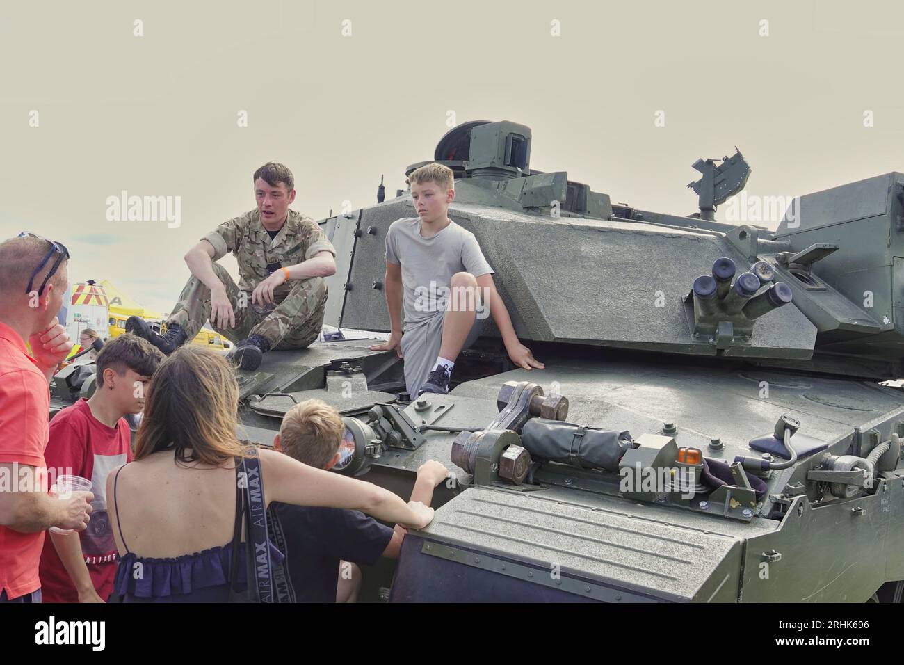 Farnborough, Hants, UK. 17th Aug, 2023. Scenes on the first day of the British Motor Show on Farnborough International Airport. Our picture shows: Youngsters climb aboard a British Army tank to experience the driving position and the tight confines of the fitting machine. Credit: Motofoto/Alamy Live News Stock Photo