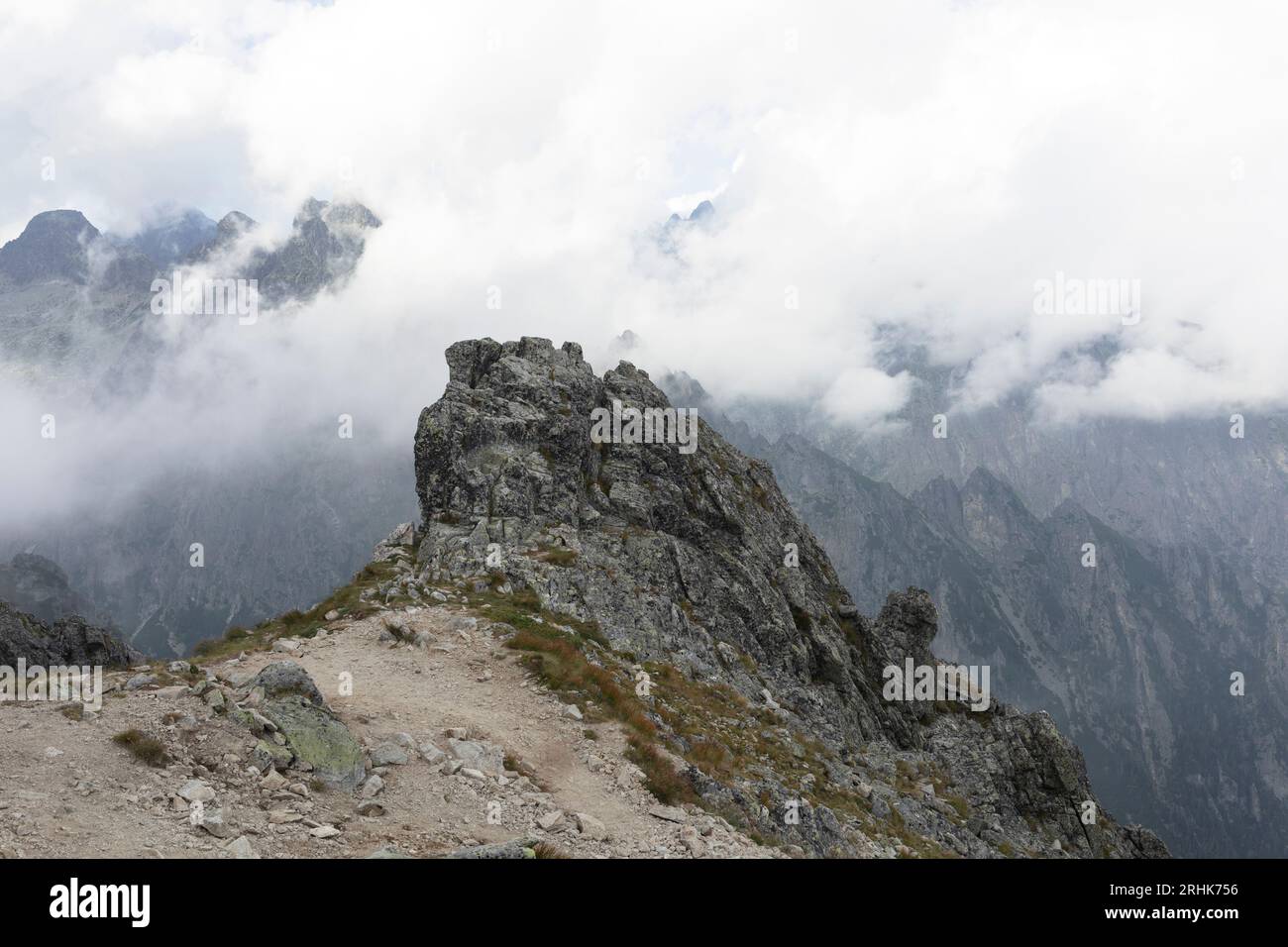 Slavkovsky stit, Vysoke Tatry, High Tatras, Slovakia. Rock and summit, peak and top of mountain the background. Hills covered by mist and foggy in fog Stock Photo