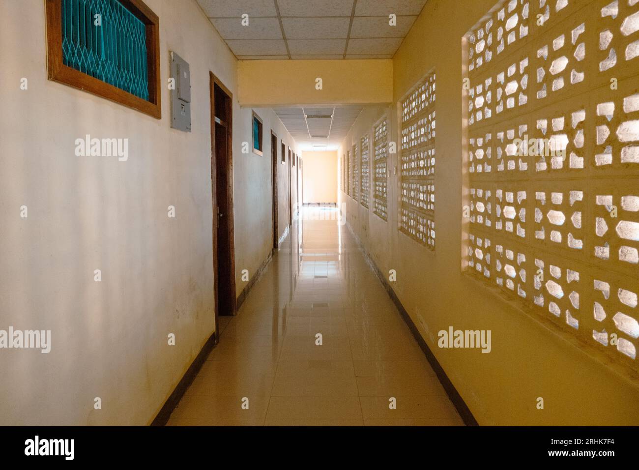 Scenic view of an empty hotel hallway with doors and windows in Mbeya, Tanzania Stock Photo