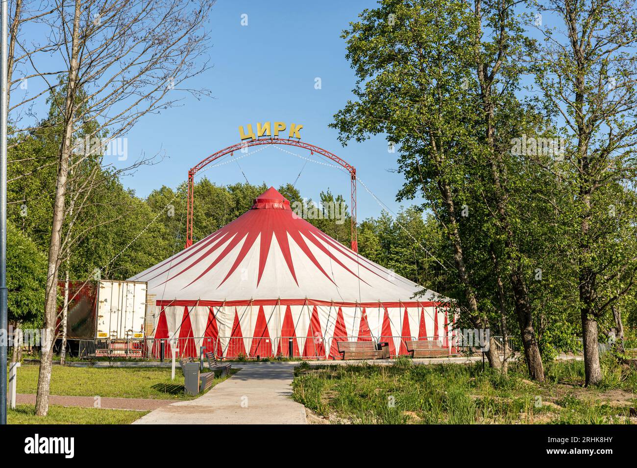 a redandwhite striped traveling circus tent is installed in the city