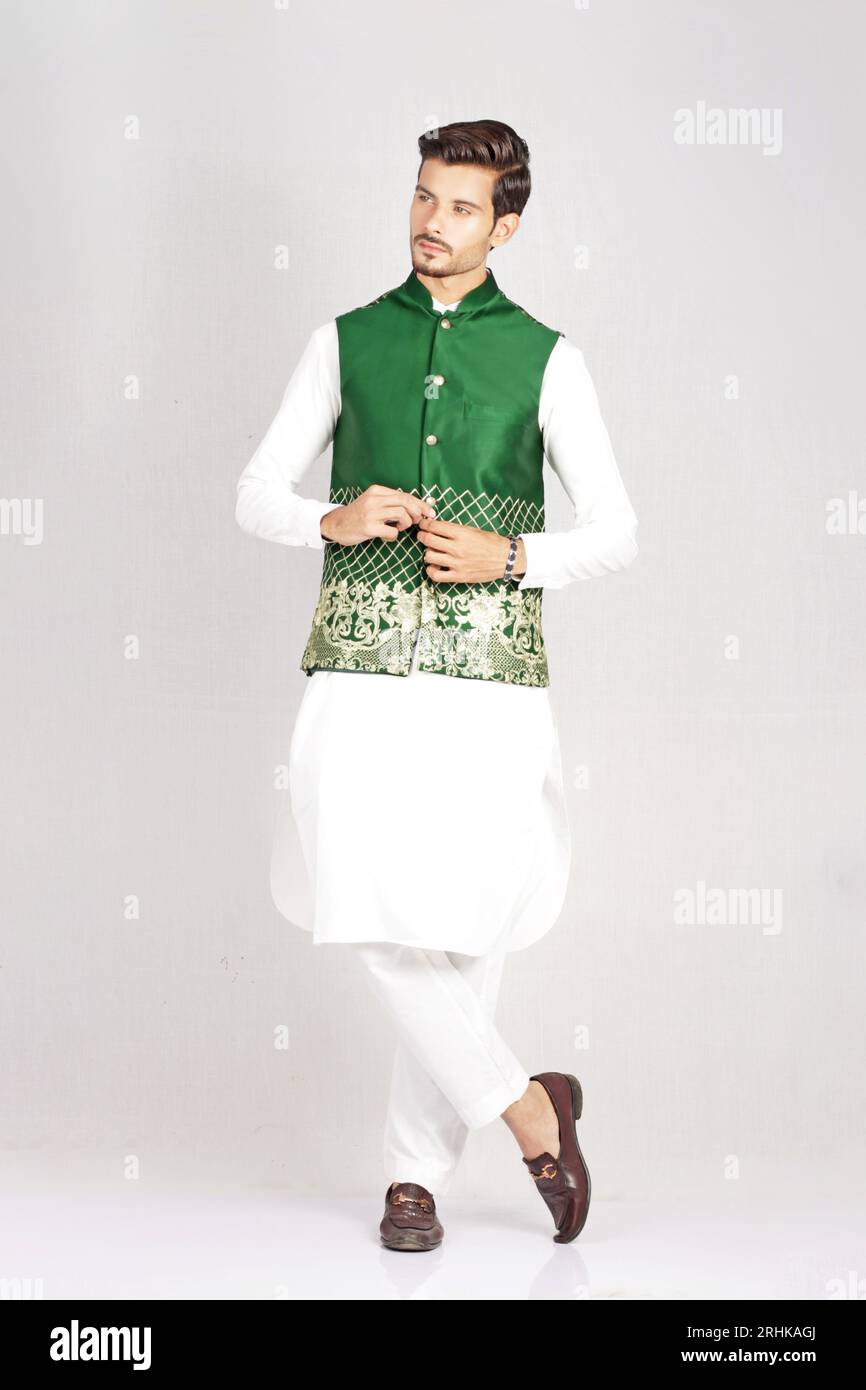 MALE MODEL POSING IN PAKISTANI TRADATIONAL DRESS Stock Photo