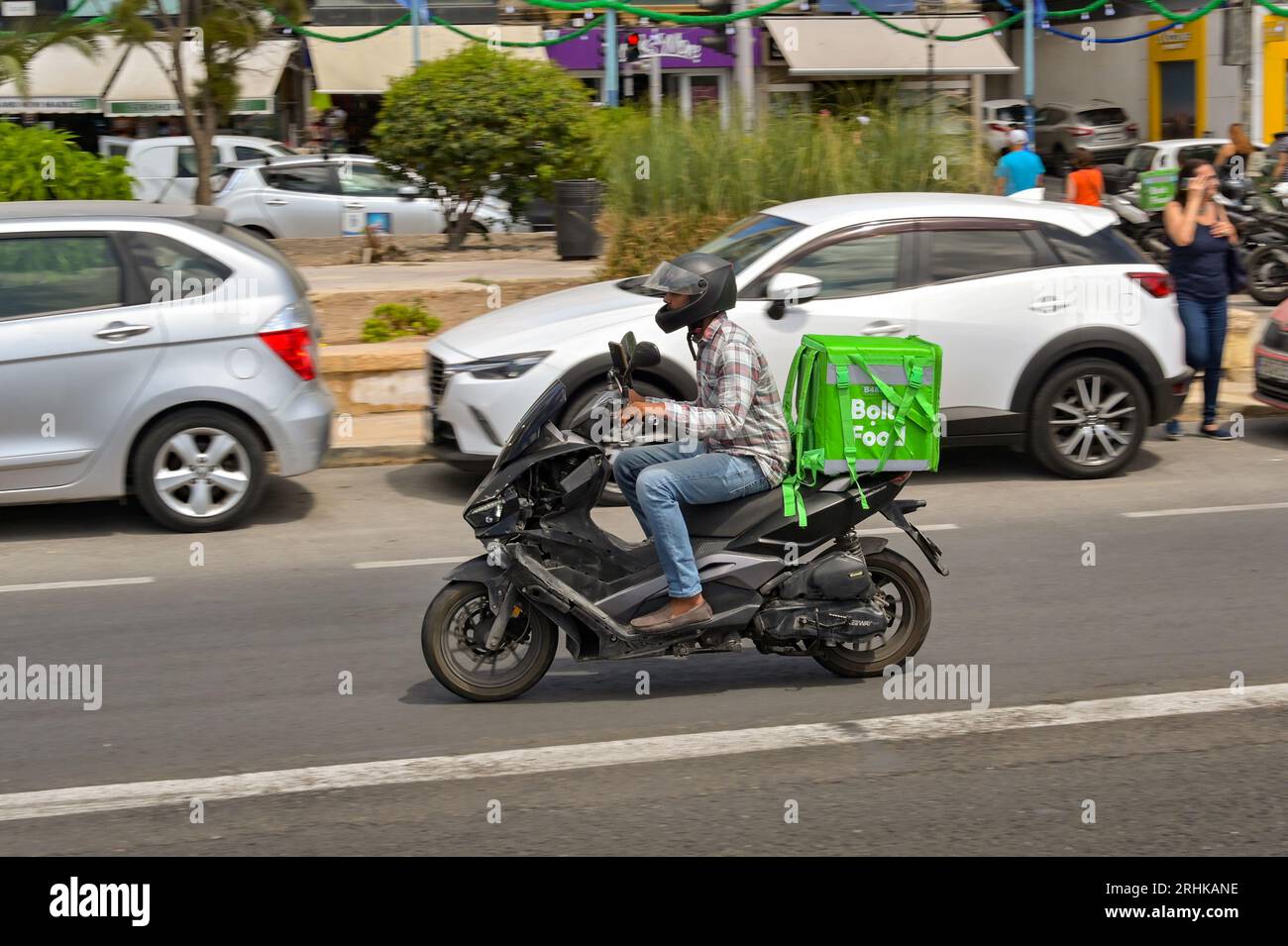Sliema, Malta 6 August 2023 Person riding a motor scooter with an