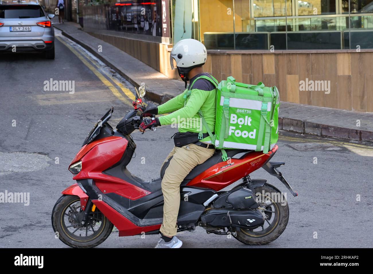 St Julians, Malta 4 August 2023 Person riding a motor scooter with