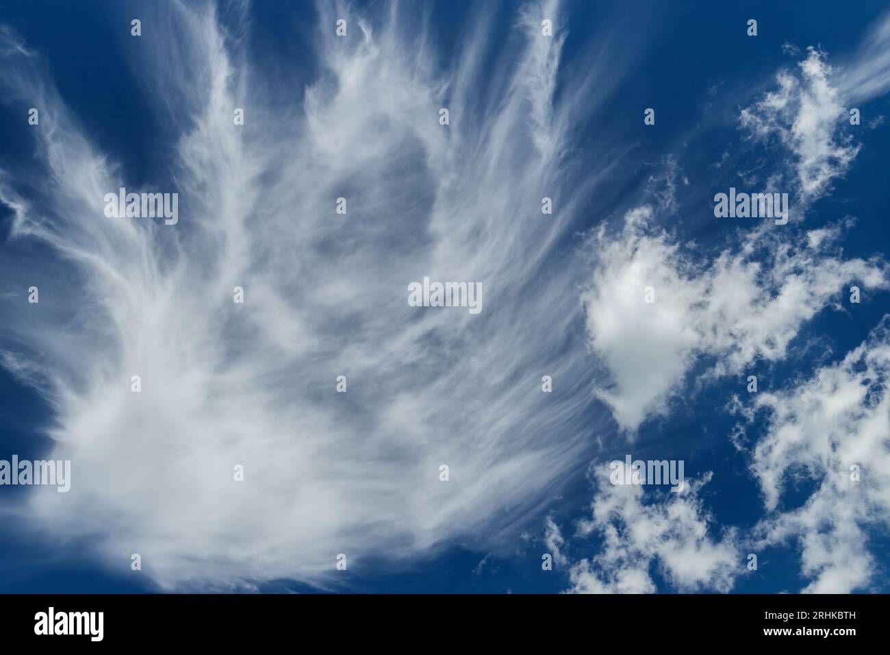 Nice white clouds on dark blue background during windy day Stock Photo