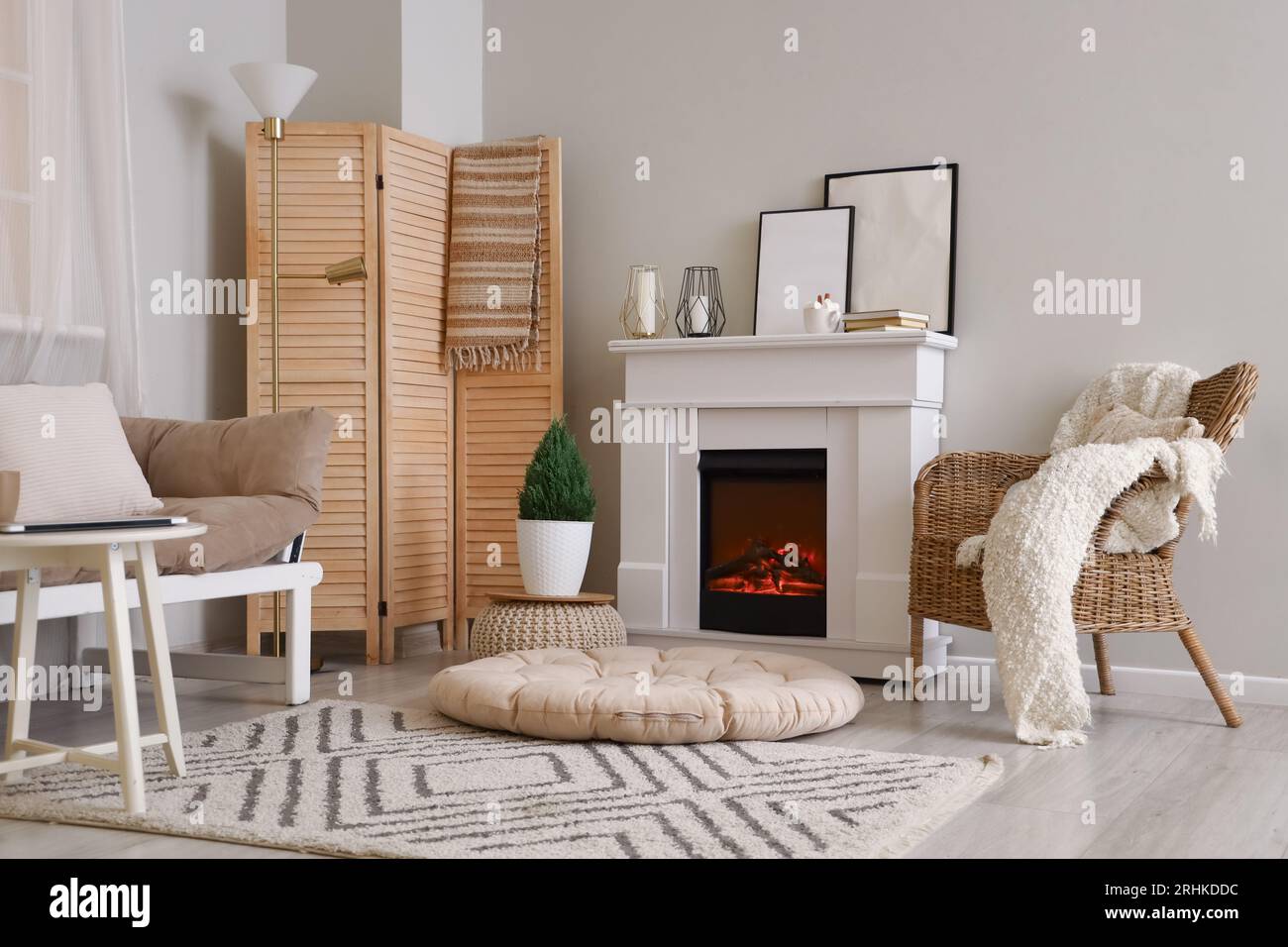 Interior of cozy living room with fireplace and armchair Stock Photo ...