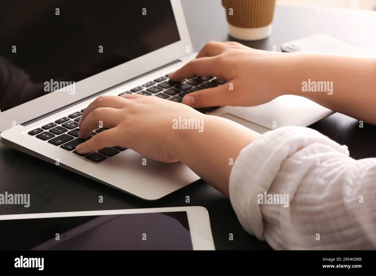 Female programmer typing on laptop keyboard at her workplace in office ...