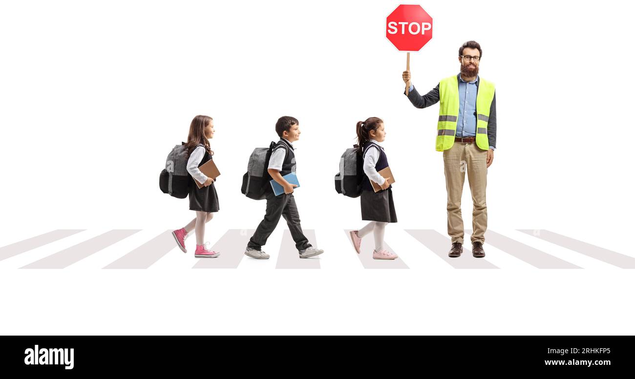 Man with a stop sign and and children crossing a street at a pedestrian crosswalk isolated on white background Stock Photo