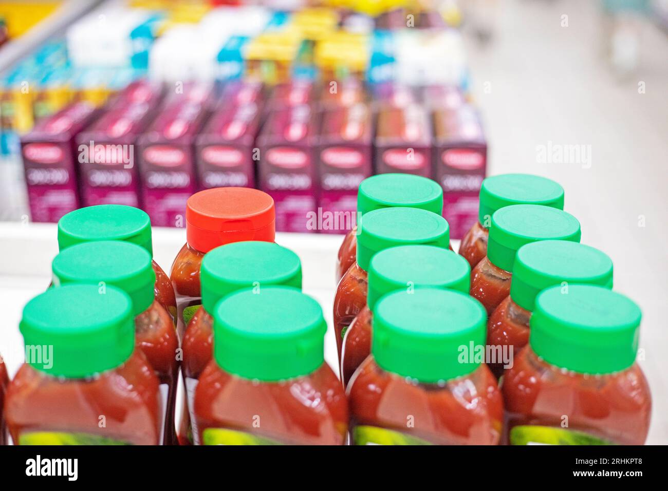 sauces and condiments wrapped in plastic lids in a supermarket Stock