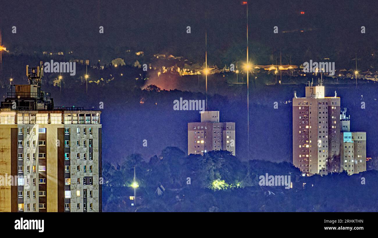 Glasgow, Scotland, UK. 17th  August, 2023.   Huge fir xintunyes to burn through the night e south of the city pictured from ten miles away beyond the towers of pollockshields .  Credit Gerard Ferry/Alamy Live News Stock Photo