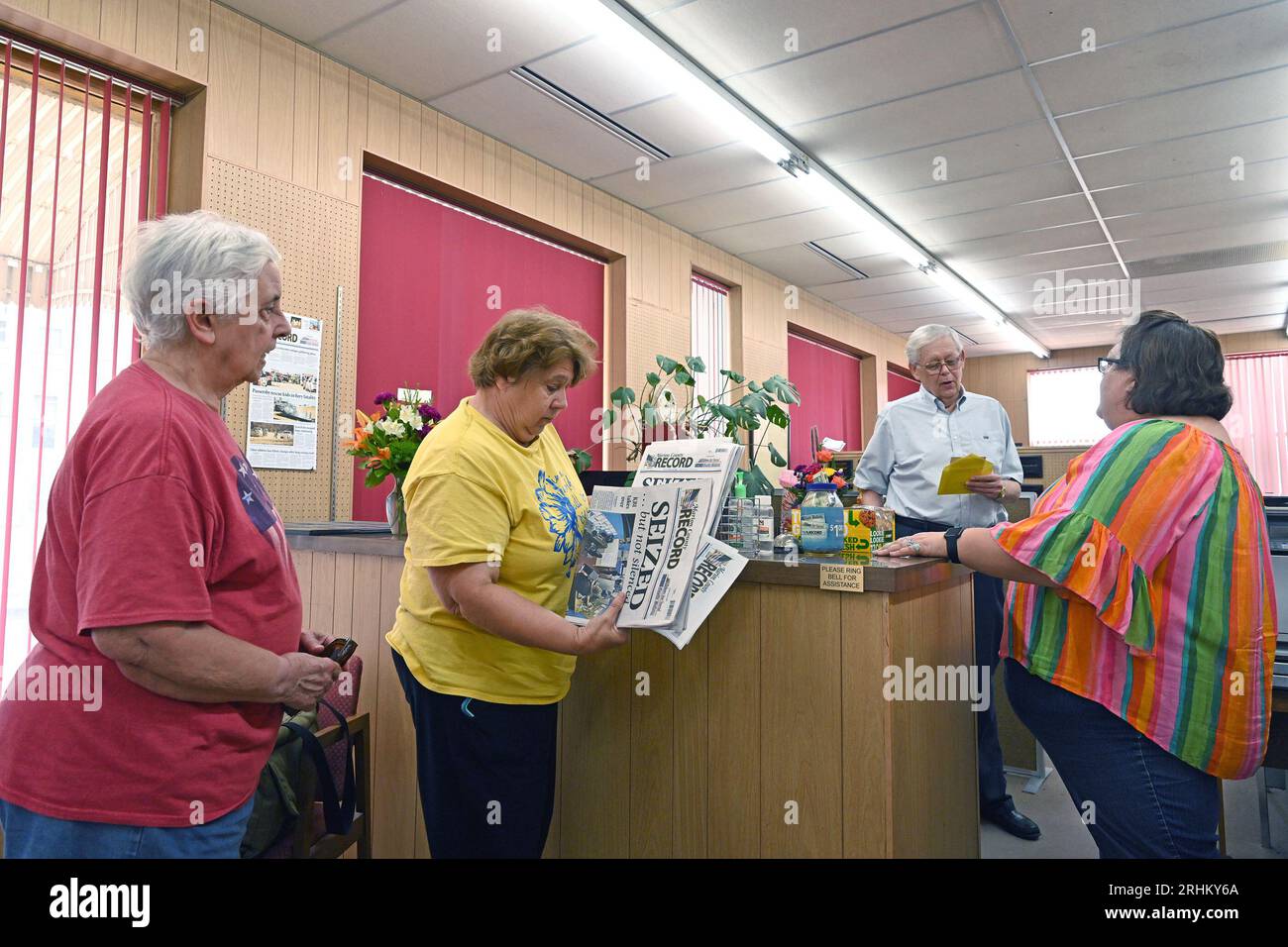 MARION, KANSAS - AUGUST 17, 2023Eric Meyer C) publisher of the Marion County Record Newspaper chats with two women (L) who drove from Grander Kansas today to buy copies of this weeks edition of the paper Cheri Bentz staffer at the paper (R) Credit: Mark Reinstein/MediaPunch Stock Photo