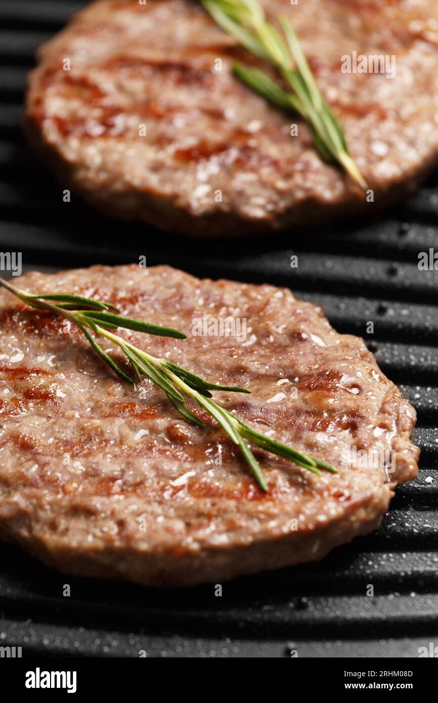 Beef patties for a burger are fried with spices on a smart electric